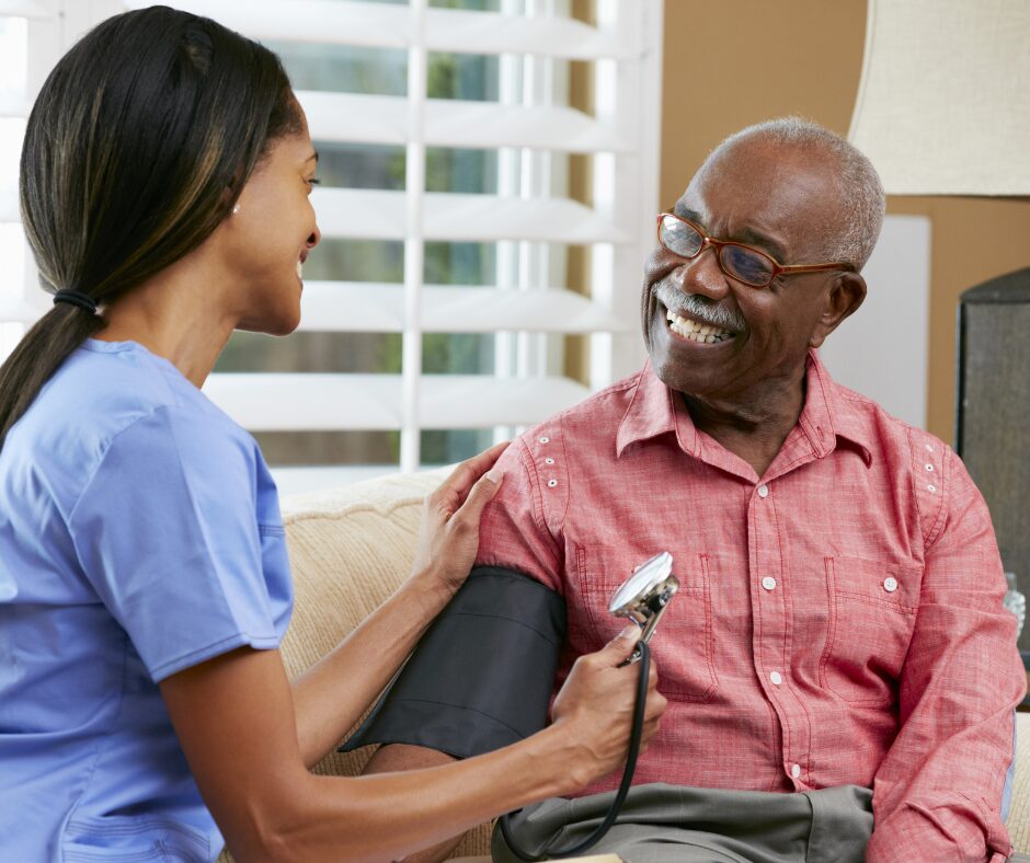 Home nurse taking blood pressure of older patient